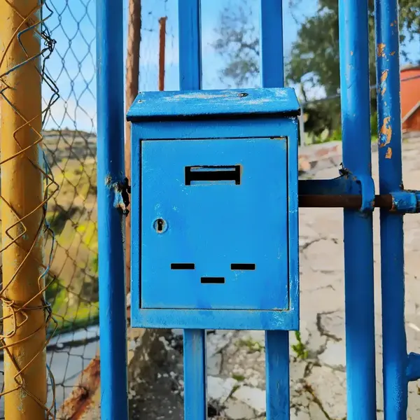 Blue metal mailbox fence