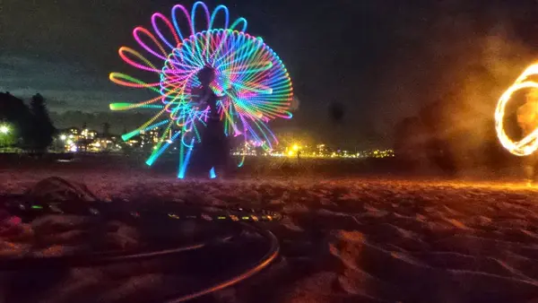 LED hula hoop and fire spinning night (Long exposure shot)
